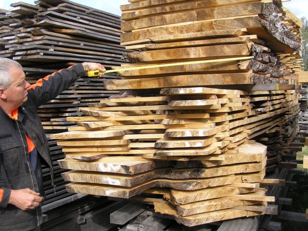 Richard Parsons, sawmiller measuring stripped out Outaniqua yellowwood boards.